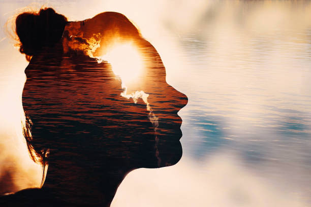 Sun peeks out from behind the clouds in woman’s head.
